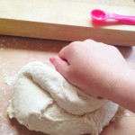 one hand kneading dough