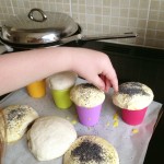 putting poppyseeds on bread dough